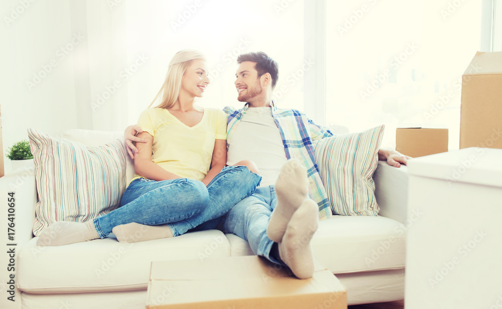 happy couple with big cardboard boxes at new home happy couple with big cardboard boxes at new home
