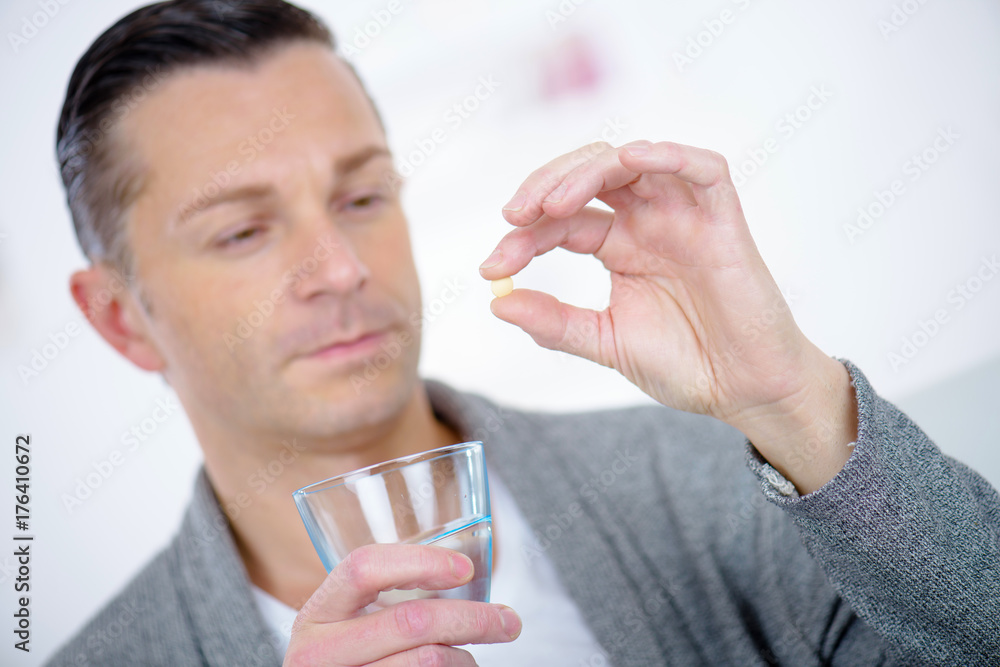 man taking his vitamins man taking his vitamins