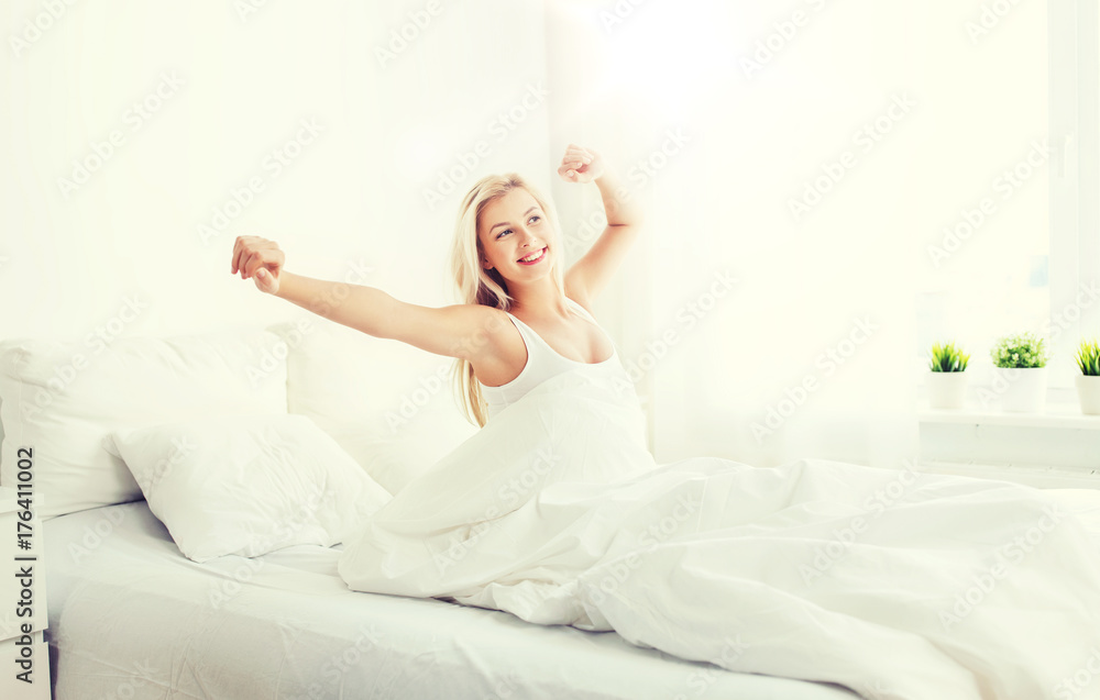 young woman stretching in bed at home bedroom - obrazy, fototapety, plakaty 