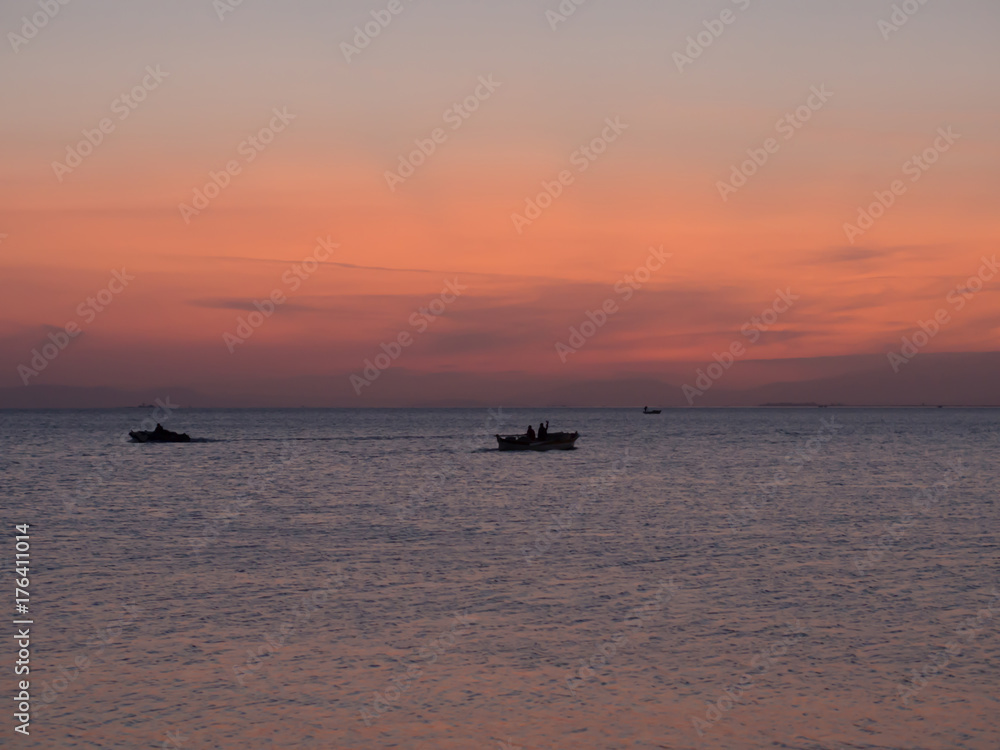 small boats at sunset