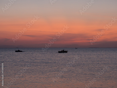 small boats at sunset