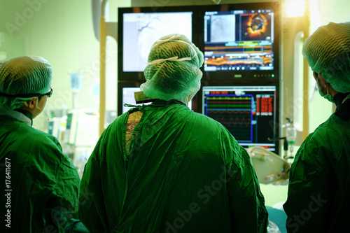 surgeon doctor with coronary monitor. photo