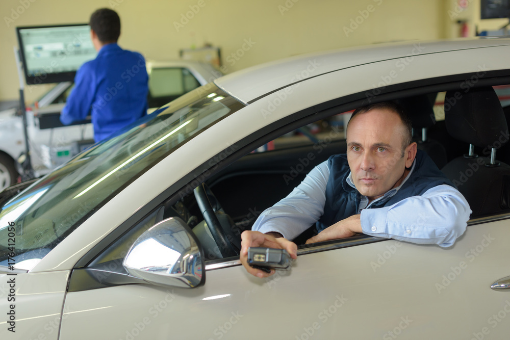 man operating controls in vehicle test station man operating controls in vehicle test station