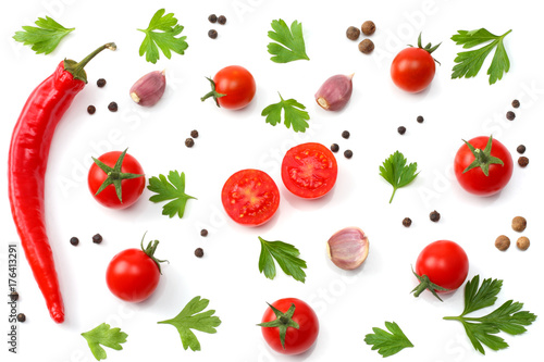 slice of tomato with chili pepper, garlic and parsley isolated on white background. top view