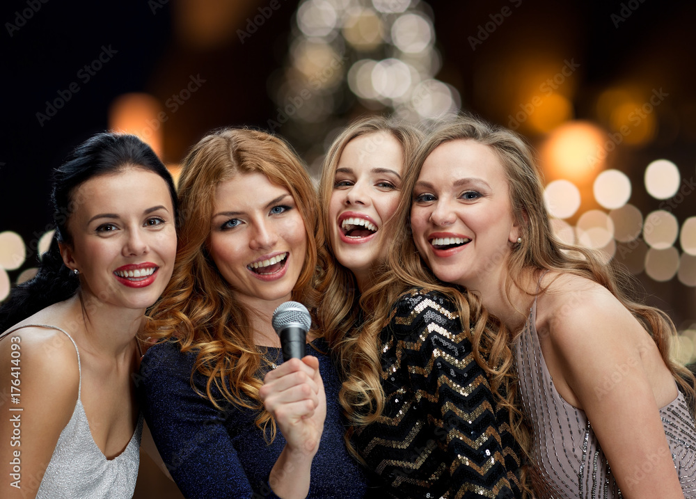 women with microphone singing karaoke at christmas women with microphone singing karaoke at christmas