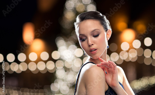 beautiful asian woman with earrings at christmas