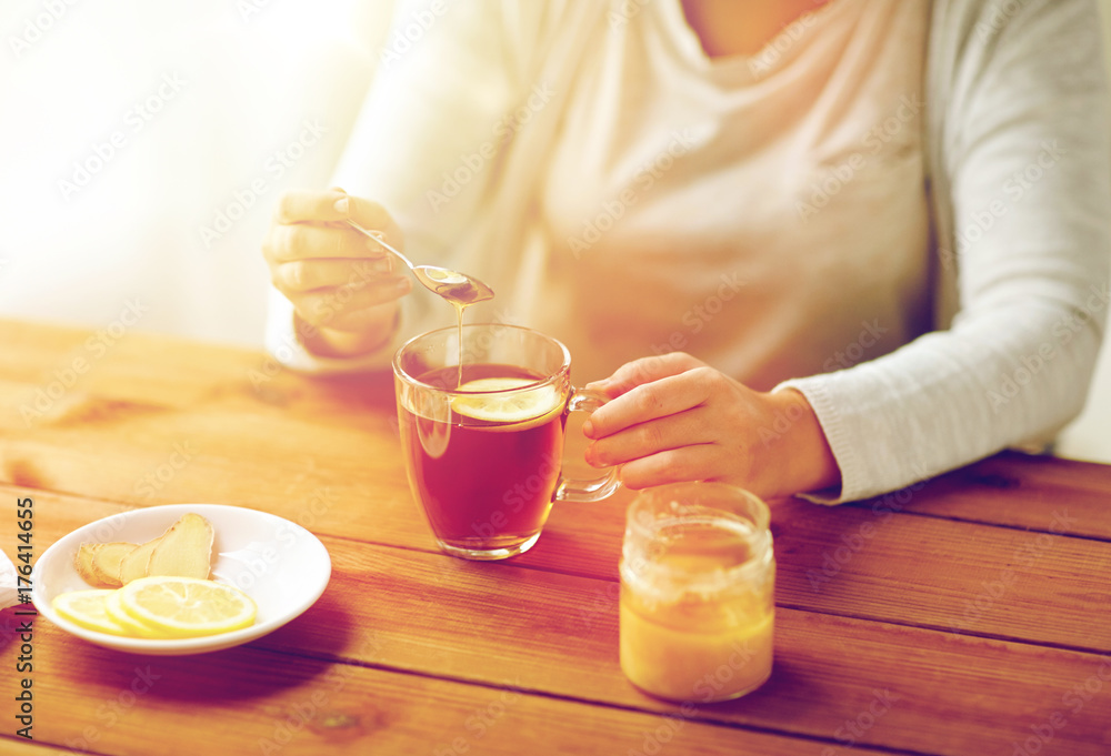 close up of ill woman drinking tea with lemon close up of ill woman drinking tea with lemon