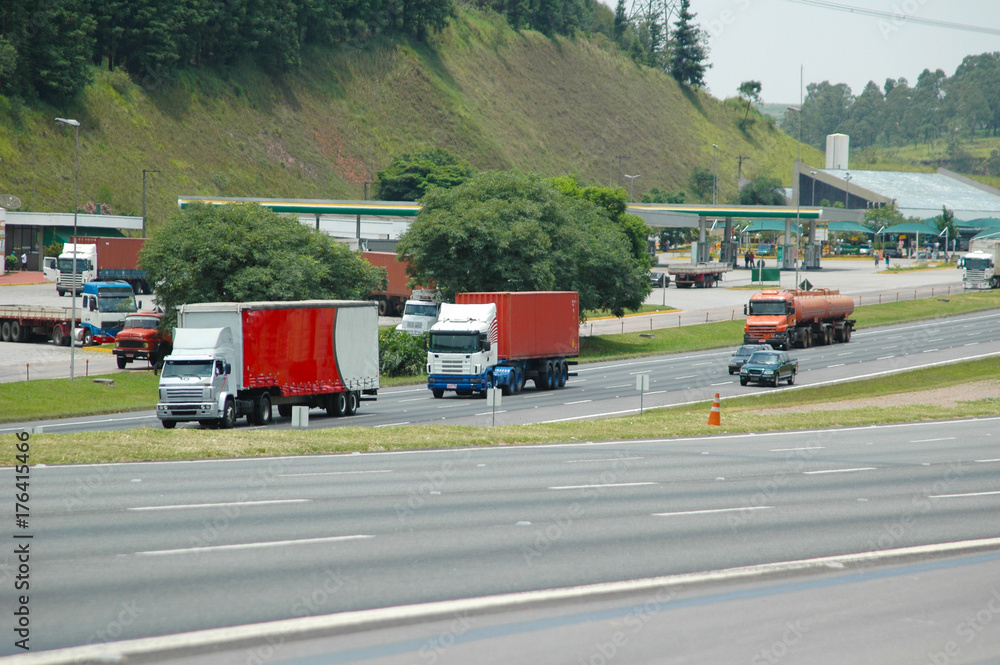 big trucks and passenger cars on major highway