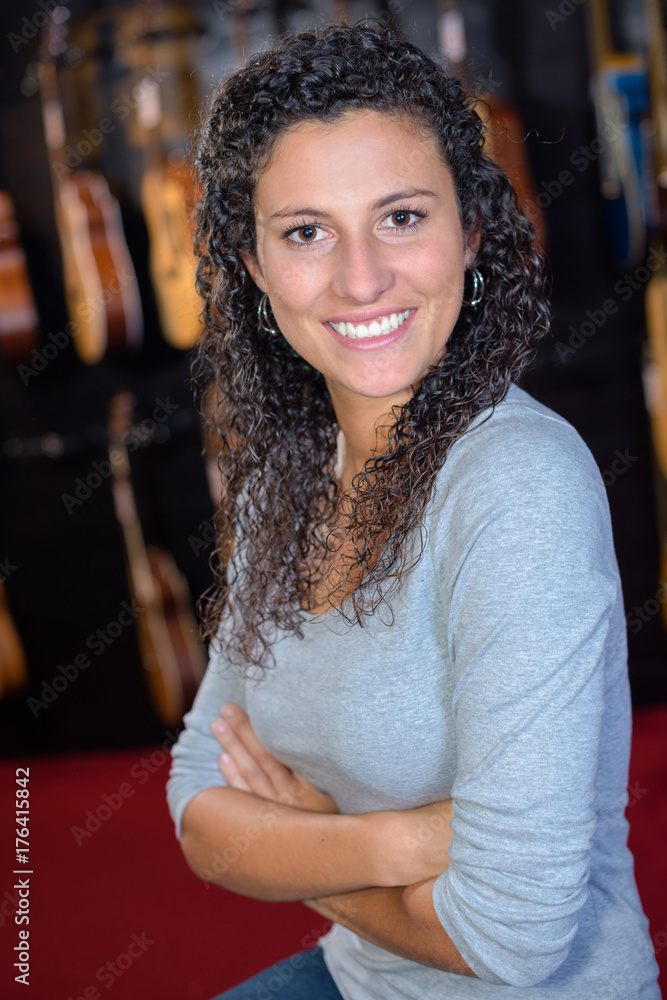Portrait of woman in musical instrument shop Portrait of woman in musical instrument shop