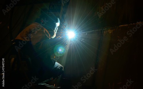 Woman worker welding