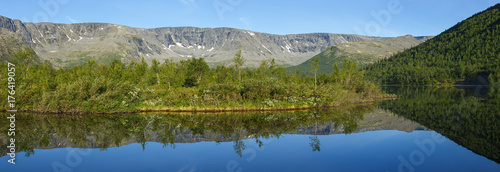 panorama with the mountains of the Khibiny, sky reflected in the lake Small Vudyavr. Kola Peninsula, Russia. photo