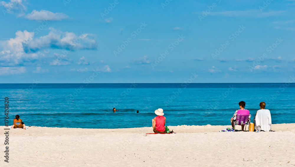 Family and friends relaxing at a beach / Family and friends relaxing on vacation at a tropical beach on the Gulf of Mexico Family and friends relaxing at a beach / Family and friends relaxing on vacation at a tropical beach on the Gulf of Mexico
