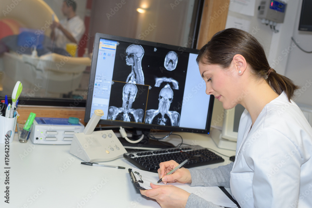 Medical worker analysing scan results Medical worker analysing scan results
