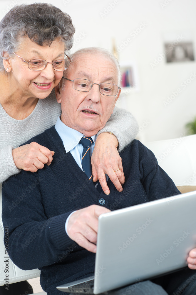 senior couple excited in seeing family members on the internet