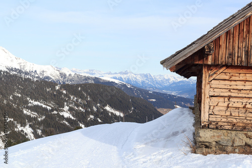 Alpine chalet house and mountain panorama with snow in winter in Stubai Alps, Austria