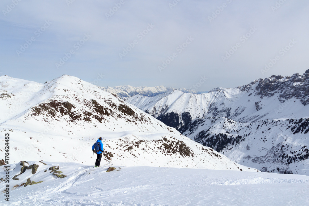 Man on ski looking at mountain snow panorama before downhill in Stubai Alps, Austria