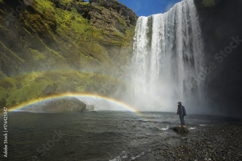 Tourist standing near Skogafoss waterfall  Iceland
