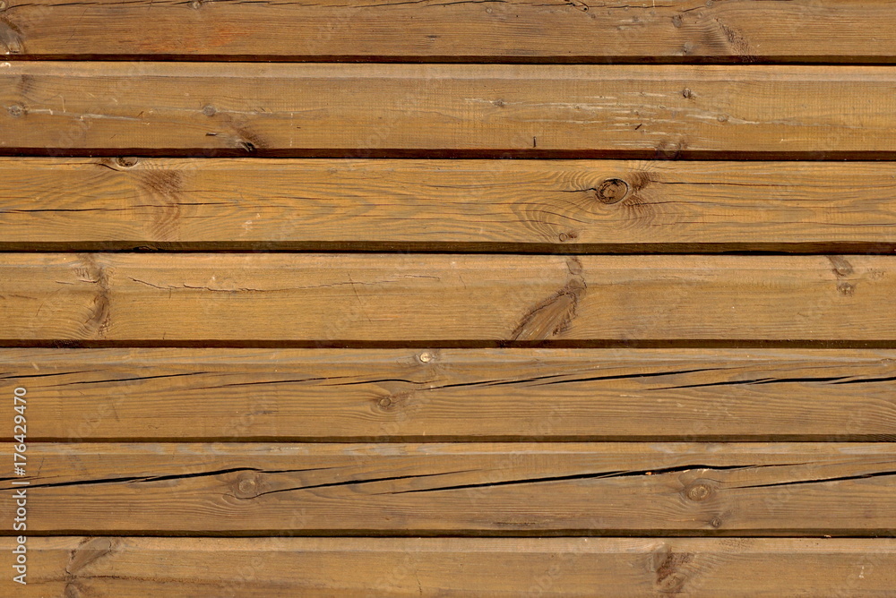 Fototapeta premium Horizontal brown wooden strips with cracked background texture