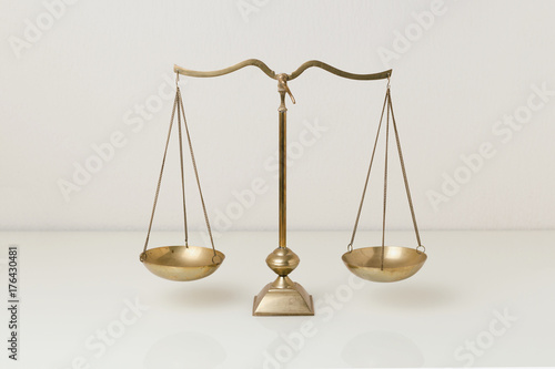 Photos Gold brass balance scale on white glass table