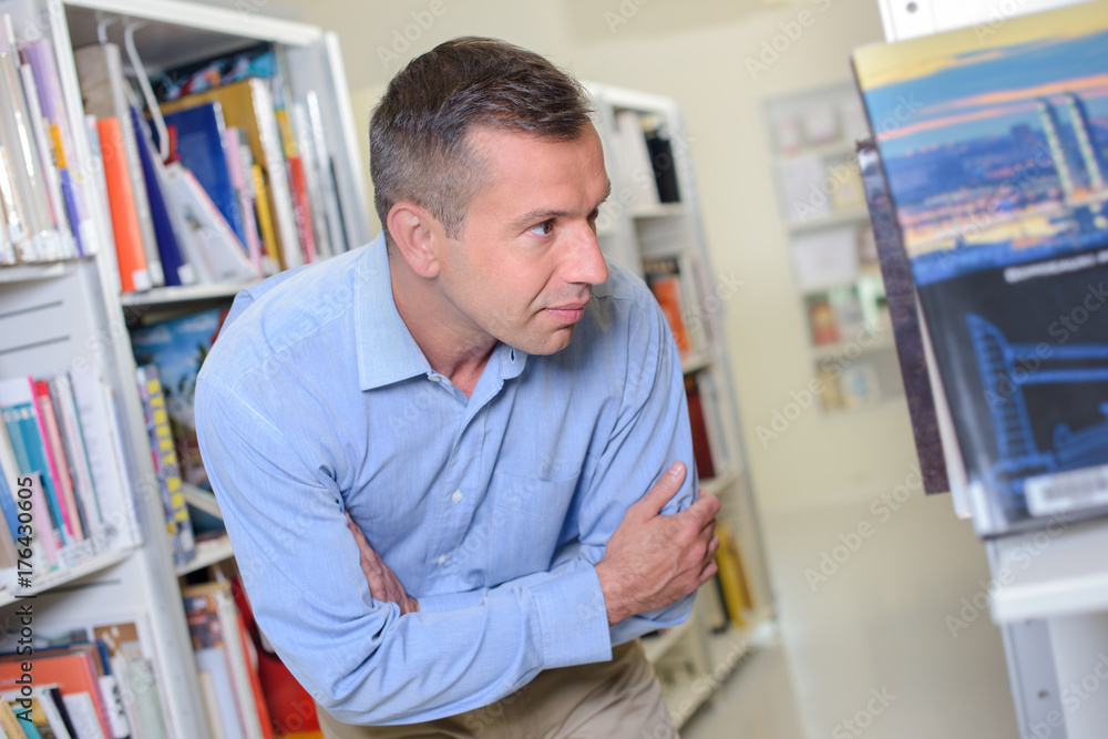 man searching for a specific book man searching for a specific book