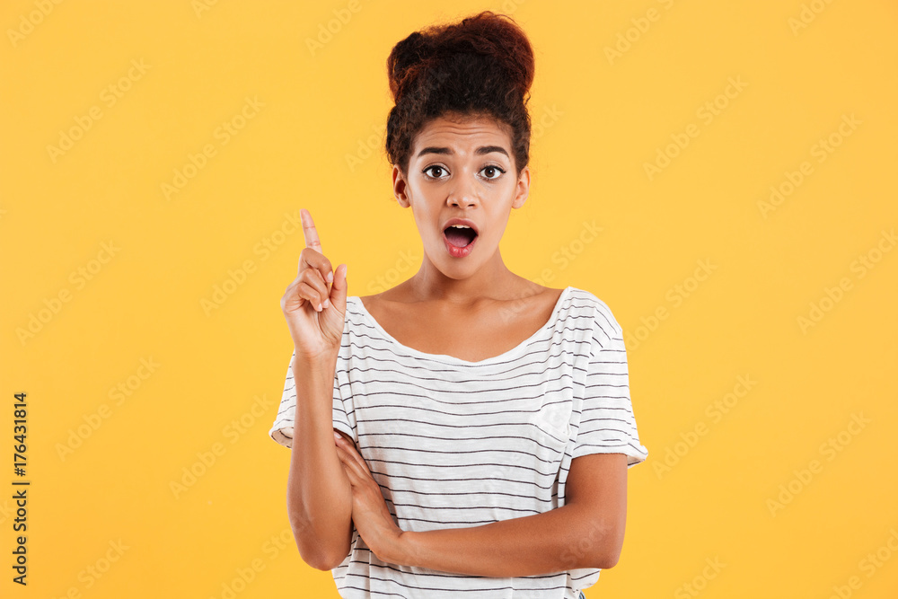 Happy surprised lady having idea iolated over yellow Happy surprised lady having idea iolated over yellow
