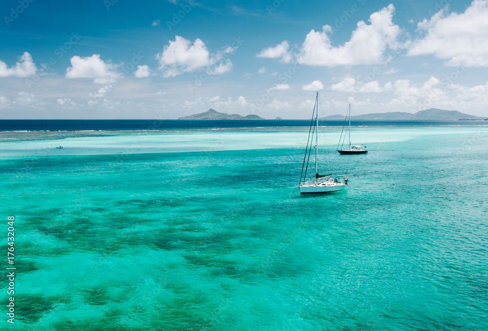 Sailboats anchored in tropical island paradise Sailboats anchored in tropical island paradise