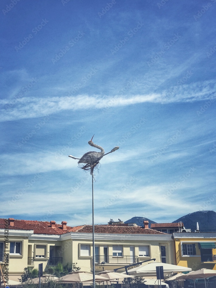 large bird installation on a street lamp in Tirana center. large bird installation on a street lamp in Tirana center.