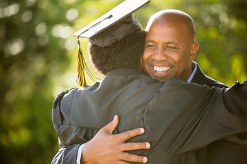 Father hugging his son at his graduation.