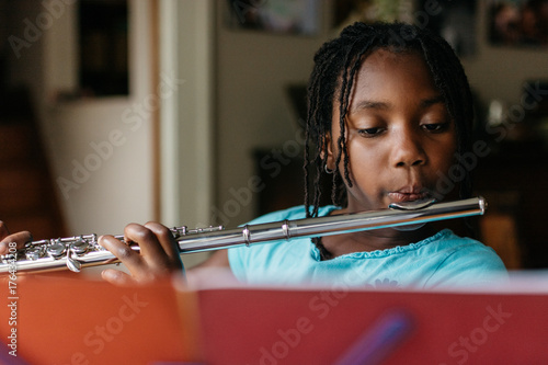Young African American girl practicing flute photo