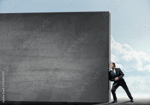 Businessman push wall