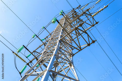 High voltage electric tower against the blue sky. Power transmission line