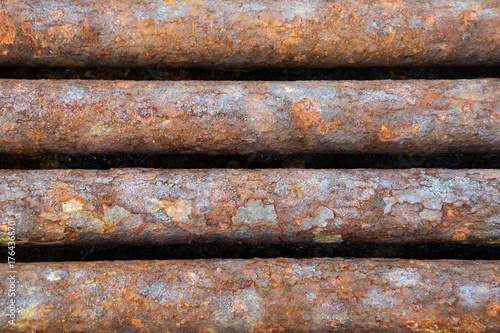 rusted discarded industrial pipes
