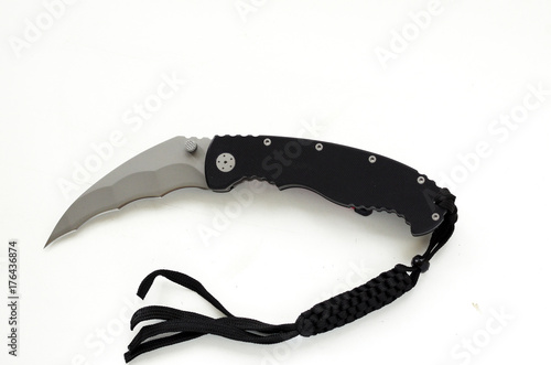 A pocket knife with a curved blade on a white background. photo