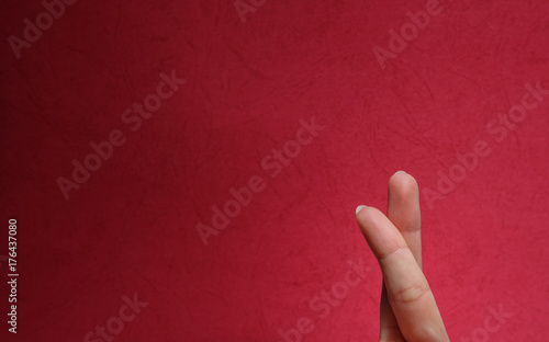 Two fingers on a red background, concept of lovers