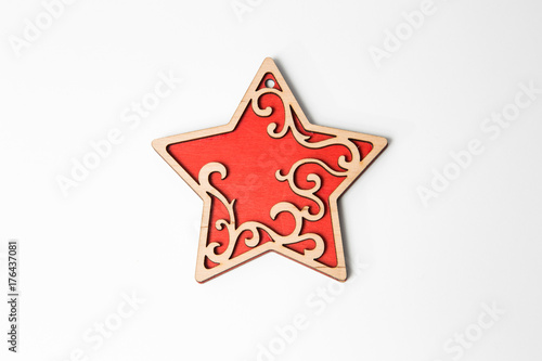 Red wooden christmas star ornament on white