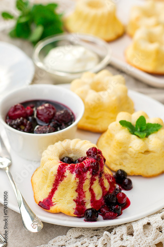 Baked sweet ricotta pudding cheesecake with sour cream and berries photo