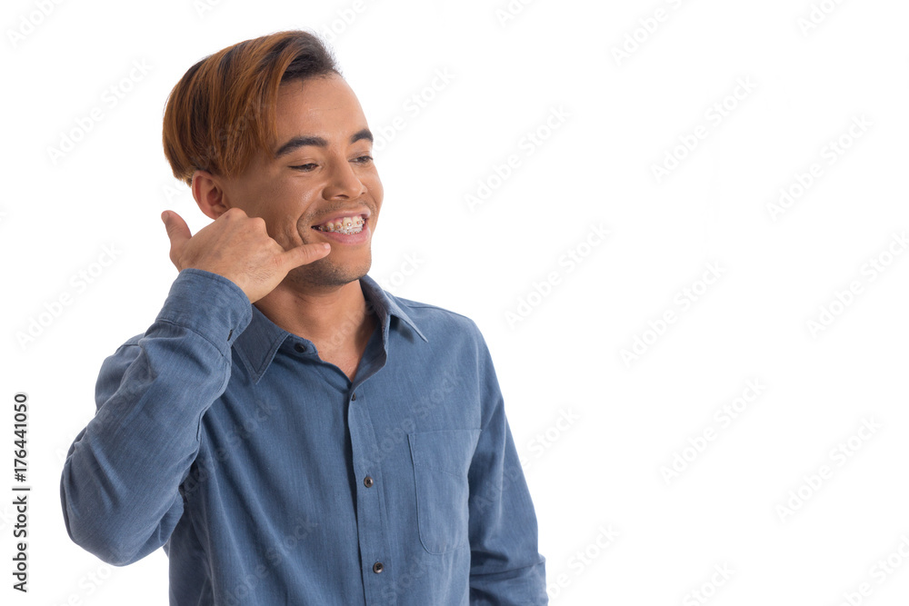 Man gestures to phone. Black young man wears blue social shirt.. Man gestures to phone. Black young man wears blue social shirt..