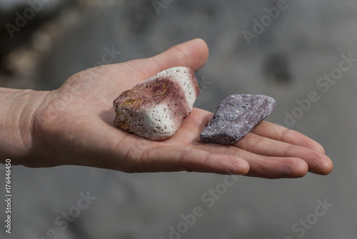 A hand holding colorful stones