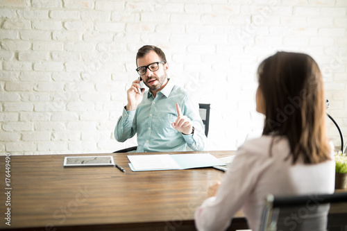 Male boss making client wait in an office