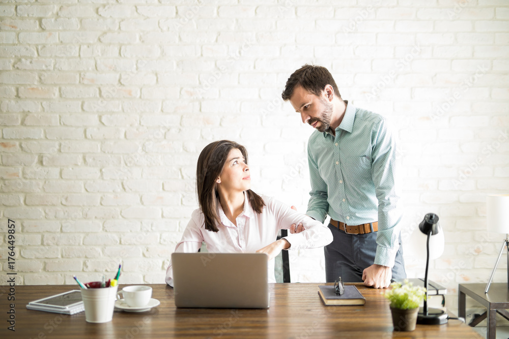 Fototapeta premium Abusive boss harassing a coworker