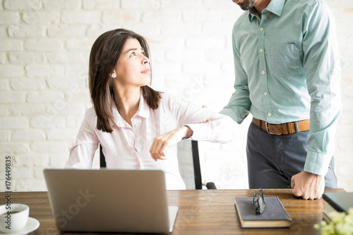 Young woman harassed by her boss at the office