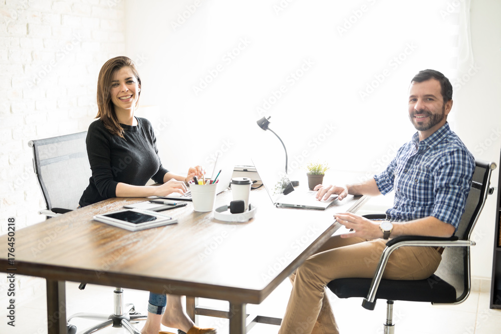 Latin business partners in an office Latin business partners in an office