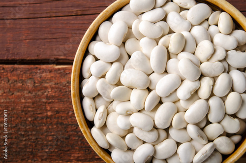 White kidney bean in bowl on wooden background. Horizontal