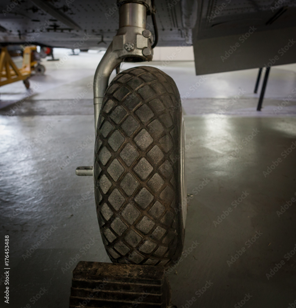 Old airplane landing gear wheel closeup.