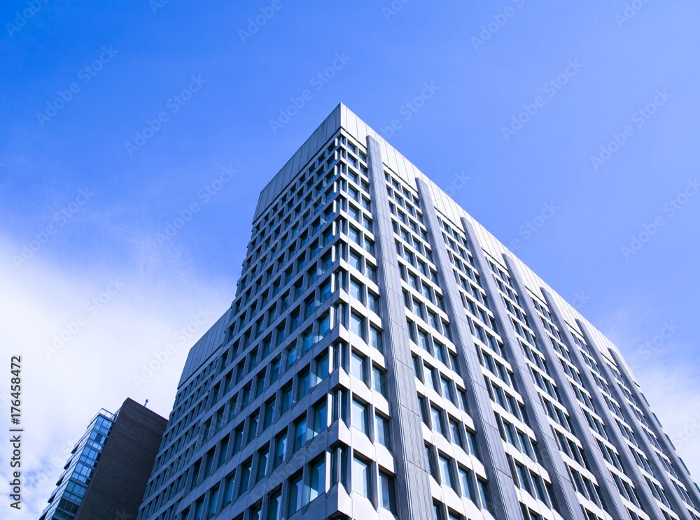 Tall corporate office building with blue sky Tall corporate office building with blue sky