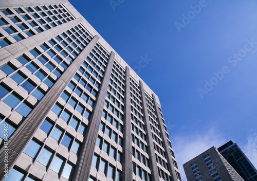 Tall corporate office building with blue sky
