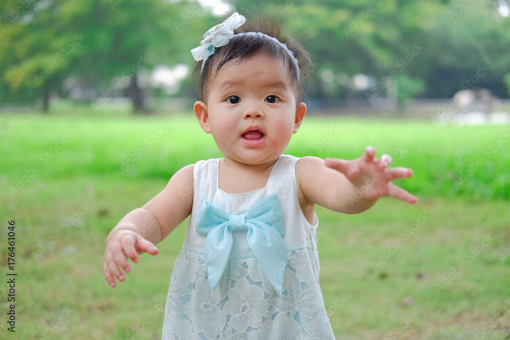 Asian Adorable baby girl playing in park. Beautiful smiling cute baby Asian Adorable baby girl playing in park. Beautiful smiling cute baby