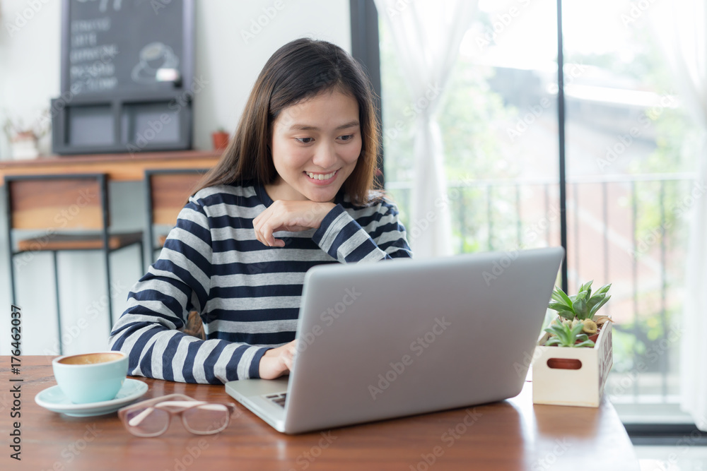New generation asians business woman using laptop at coffee shop,Asian women sitting smiling while working on mobile office concept New generation asians business woman using laptop at coffee shop,Asian women sitting smiling while working on mobile office concept