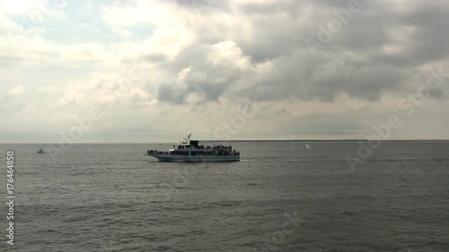 Humpback whale watching near province-town p-town Cape Cod Massachusetts.  Summer tourist tourism attraction passengers crowded boat ferry business photo