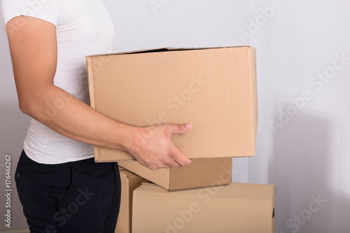 Man Carrying Cardboard Box © Andrey Popov